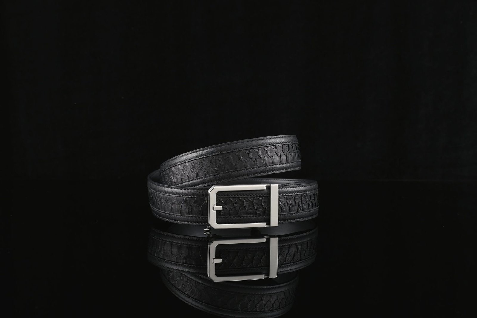 A coiled leather belt with a steel buckle.